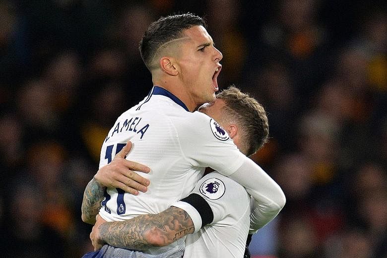 Erik Lamela celebrating with Kieran Trippier after scoring the first of Tottenham's three goals on Saturday. Wolverhampton Wanderers later scored two penalties with 11 minutes to go but Spurs held on to win 3-2.