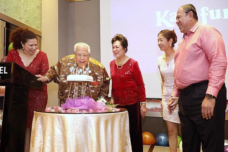 Former national sprinter and Olympian Kesavan Soon blowing out the candles on his birthday cake, accompanied by his wife June (right) and daughter Paula, while celebrating his 80th birthday at the M Hotel yesterday. Among the 200 guests present inclu