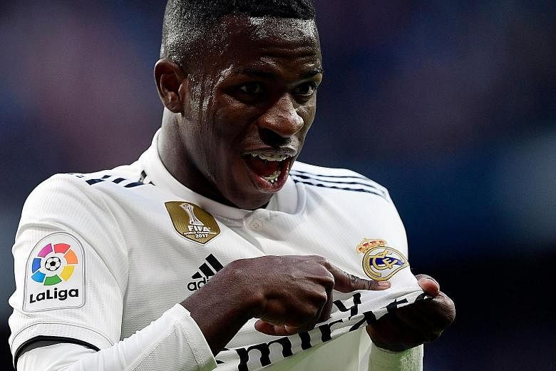 Vinicius Junior pointing to the club badge on his jersey as he celebrates Real Madrid's opener in the 83rd minute - an own goal, after his shot deflected off Real Valladolid's Kiko Olivas.