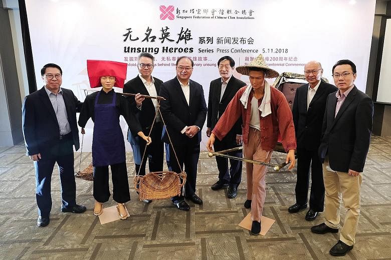 Singapore Federation of Chinese Clan Associations president Tan Aik Hock (third from left) and other leaders posing with mannequins of a samsui woman and a rickshaw puller. The federation will be celebrating the nation's bicentennial with eight proje
