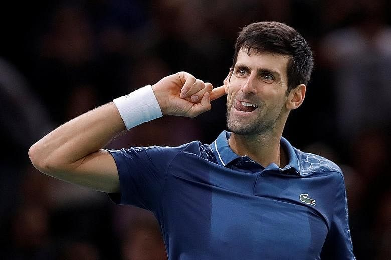 Novak Djokovic plays to the crowd after his marathon 7-6 (8-6), 5-7, 7-6 (7-3) victory over Roger Federer at the Paris Masters on Saturday.
