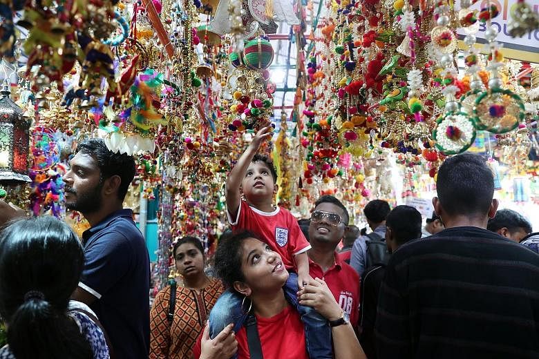 Perched on his mother's shoulders, five-year-old Aaryan Arunan had a better view than most at the Deepavali festival bazaar in Little India yesterday. It was also the perfect spot for the kindergarten pupil to touch the many colourful decorations tha