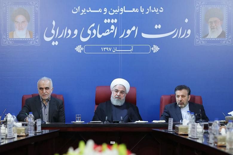 Iran's President Hassan Rouhani (centre) at a Cabinet meeting in the capital Teheran. He said the country is "in a situation of economic war, confronting a bullying power", as sanctions by the US took effect yesterday.