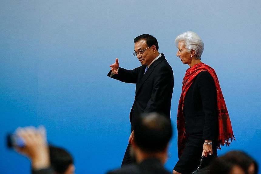 Chinese Premier Li Keqiang and International Monetary Fund managing director Christine Lagarde meeting the press after their "1+6" Roundtable session in Beijing yesterday.
