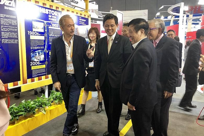 YCH Group executive chairman Robert Yap (left) showing Trade and Industry Minister Chan Chun Sing around his company's booth at the China International Import Expo in Shanghai yesterday.