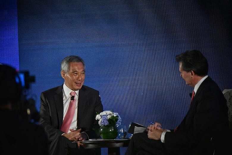 Prime Minister Lee Hsien Loong at a dialogue last night hosted by Bloomberg News' editor-in-chief John Micklethwait during a dinner for around 400 top business and thought leaders attending the Bloomberg New Economy Forum.