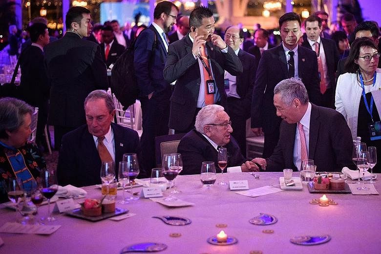 Prime Minister Lee Hsien Loong greeting Dr Henry Kissinger at a welcome dinner at the Bloomberg New Economy Forum last night. With them are the PM's wife, Mrs Lee, and Bloomberg chief executive Michael Bloomberg. When asked at a dialogue with Bloombe