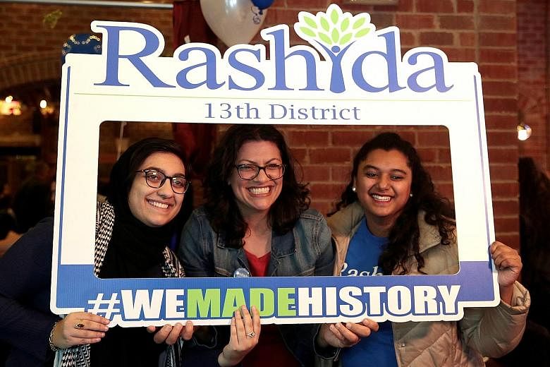 Ms Rashida Tlaib (centre of picture on the left) and Ms Ilhan Omar (above) make history as the first Muslim women elected to US Congress.