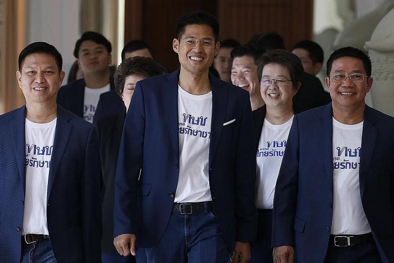 Thai Raksa Chart Party leader Preechapol Pongpanich (centre) arriving for the new party's first meeting in Bangkok yesterday. Members of the political party include the nephew and niece of former Thai premiers Thaksin Shinawatra and his sister, Yingl