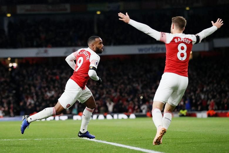Arsenal forward Alexandre Lacazette celebrates with teammate Aaron Ramsey after scoring the equaliser in the 1-1 draw with Liverpool at the Emirates Stadium on Saturday. Goalkeeper Bernd Leno said the result proved the Gunners can hold their own agai