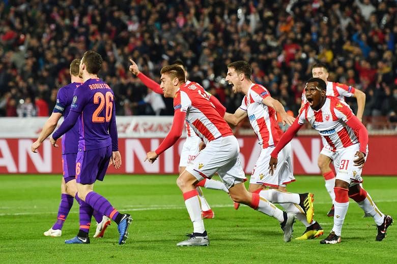 Red Star Belgrade's Milan Pavkov (centre) celebrates his first goal against Liverpool after heading home from a corner. He later doubled his tally as the Serbian champions recorded their first Champions League win this season.