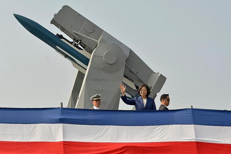 Taiwanese President Tsai Ing-wen waving from the deck of the frigate Ming Chuan during a ceremony to commission two Perry-class guided missile frigates from the United States yesterday.