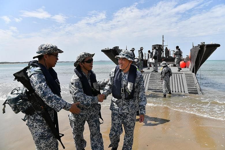 Lieutenant-Colonel Kenny Chen (third from left), head of the RSN's Command Task Group, being greeted after disembarking from a fast craft in the Shoalwater Bay Training Area in Australia. The RSN is deploying Endurance-class landing ship tank RSS Res