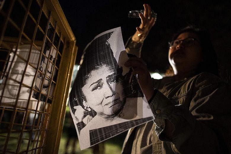 A student with a picture of Imelda Marcos at a rally to mark her corruption conviction at the University of the Philippines yesterday.