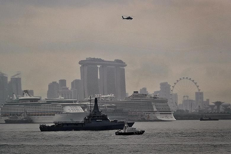 A joint patrol involving the RSS Independence, an AH-64D Apache helicopter and a Police Coast Guard boat in the anchorage off Marina Barrage yesterday. The SAF will secure Singapore's airspace and surrounding waters during the Asean Summit.