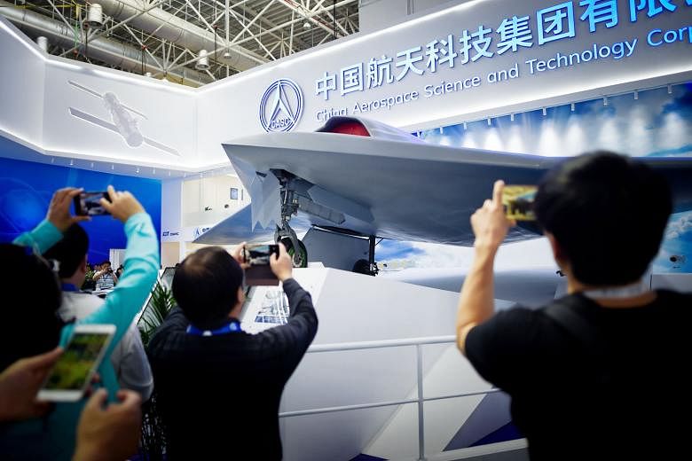 Visitors taking pictures of a stealth UAV model at Airshow China 2018 in Zhuhai this week. The show highlights China's growing production of sophisticated unmanned aerial vehicles.