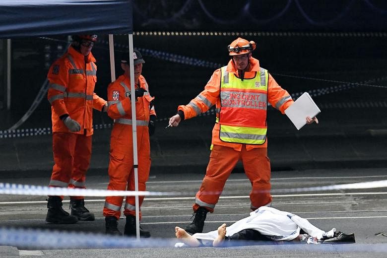 A body lying on the ground after a stabbing incident in Melbourne yesterday which police called an act of terrorism.