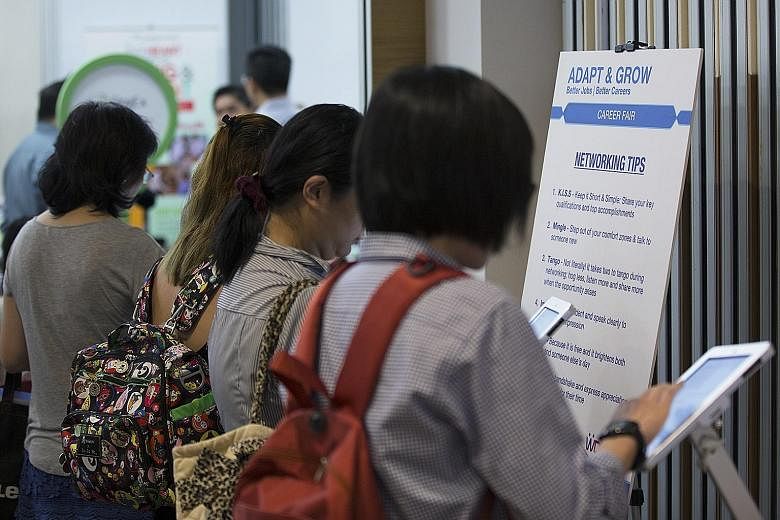Job seekers at a job fair. Experts say that while employers will look at a job applicant's highest qualifications, skills and track record, some will still ask to see O-level scores in subjects relevant to the job.