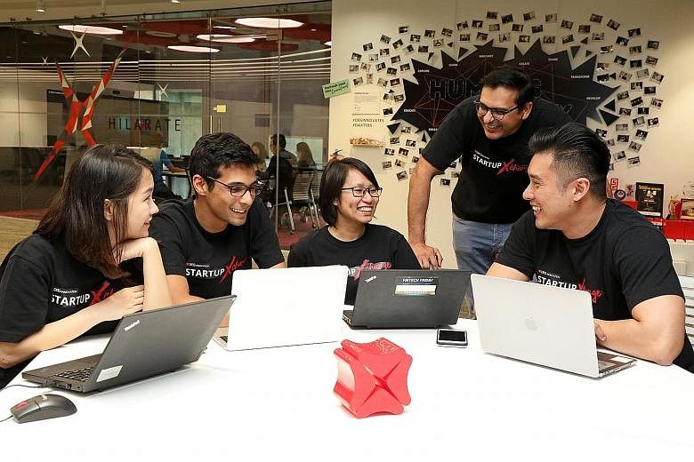 Impress.AI chief executive officer and co-founder Sudhanshu Ahuja (second from left) with DBS staff, including Mr Bidyut Dumra (second from right), the bank's head of Innovation. Impress.AI worked with DBS to come up with Jim, an acronym for "Jobs In