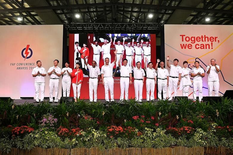 Prime Minister Lee Hsien Loong with the new line-up of People's Action Party central executive committee members elected and co-opted at the party conference yesterday. With him are (from left) Foreign Minister Vivian Balakrishnan; Education Minister