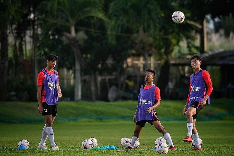 National footballers (from left) Ikhsan Fandi, Faris Ramli and Gabriel Quak training in Bacolod City yesterday. The Lions will take on the Philippines in their second AFF Suzuki Cup Group B game tomorrow night.