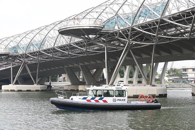 Left: Police officers checking out the Marina coastal area ahead of the summit. Right: Marina Reservoir patrol boats will ply the waters around the Marina Barrage, Singapore River and Kallang Basin during the summit.