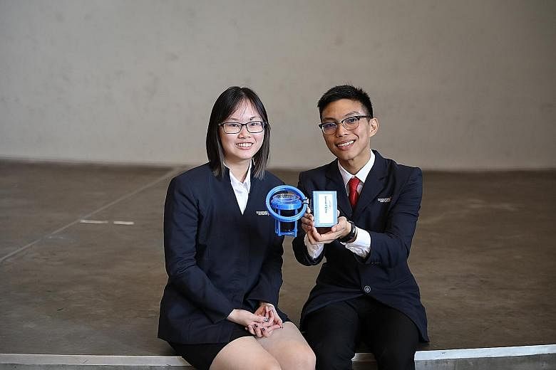 Republic Polytechnic's Azimah and Jordan Sia with their invention - a locked pill dispenser that helps patients keep track of the medication they take daily. Ms Heng Yin Qi and Mr Lee Wei Juin from SP with Shaky - a device that can be attached to obj