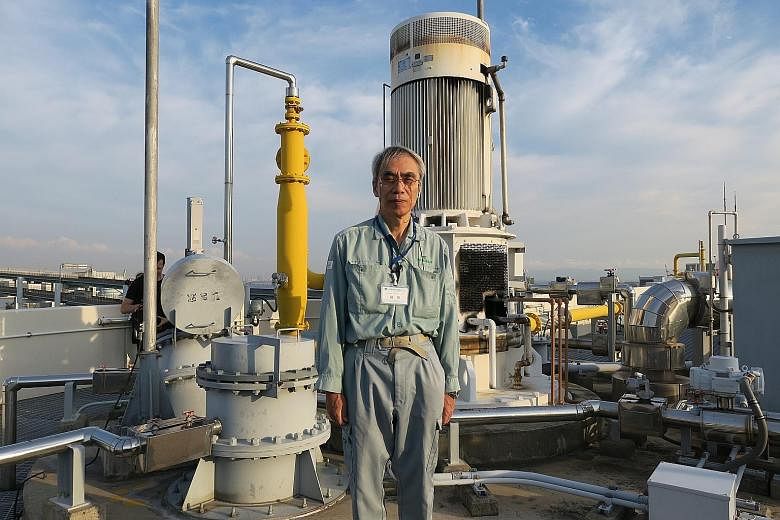 Mr Takashi Kusuda, an employee at the Higashinada sewage treatment plant, in front of a facility that refines city sewage into biogas.
