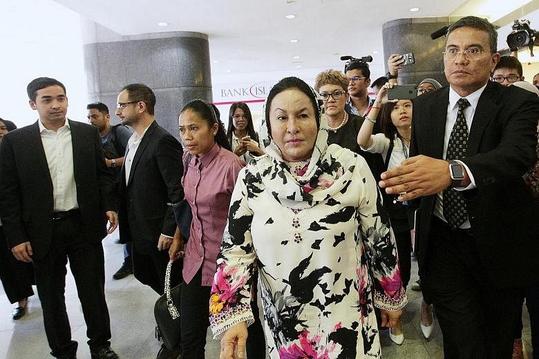 Former Malaysian prime minister Najib Razak's wife Rosmah Mansor, accompanied by her sons Ashman Najib (far left) and Riza Aziz (second from left), at Menara KPJ in Kuala Lumpur late last month to have her statement recorded by the police.