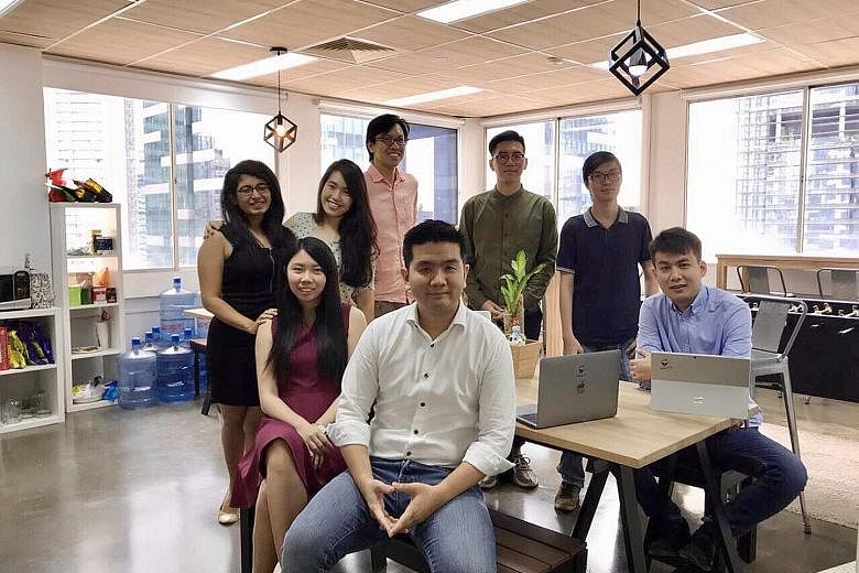 Mr Wong Hong Ting (in white), founder of artificial intelligence firm Botbot.ai, with his team. He says data-driven firms like his will face far greater technical challenges if the free flow of data across borders is restricted.