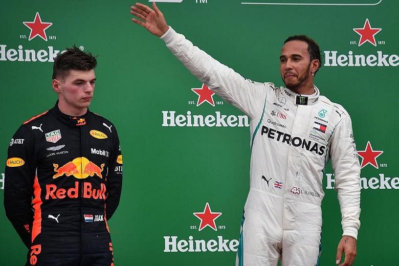 Lewis Hamilton celebrates his 10th victory of the season while Max Verstappen can only look on. The Red Bull driver's opportunity of winning back-to-back grands prix was quashed when a collision with Force India's Esteban Ocon on Lap 44 cost him the 