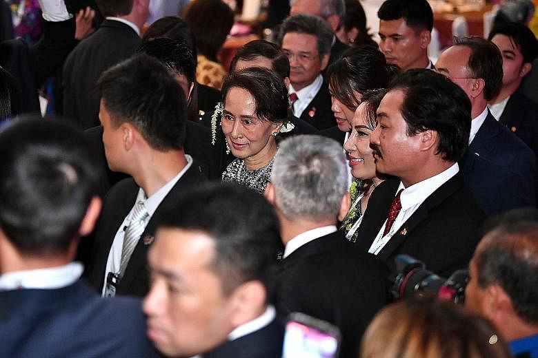 Myanmar's State Counsellor Aung San Suu Kyi taking her leave after making a keynote speech at the Asean Business and Investment Summit yesterday. She told regional policymakers and business leaders that reforms have been undertaken to make her countr