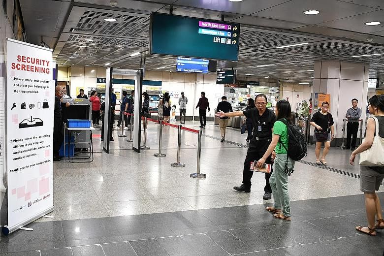 A commuter at Little India MRT station being directed to go through a security screening on the first day of the trial yesterday. The Land Transport Authority said the trial will be conducted at up to six stations across the rail network and that not