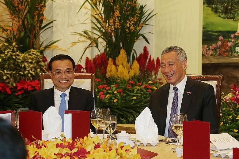 Prime Minister Lee Hsien Loong hosting Chinese Premier Li Keqiang to dinner last night. The upgraded free trade agreement will give Singapore firms stronger protection for investments. PM Lee welcoming Premier Li at the Istana yesterday during the Ch