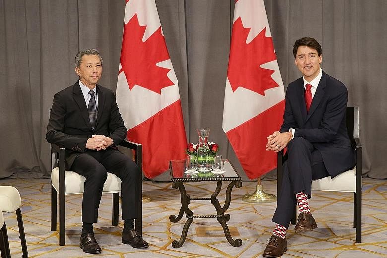 Canadian Prime Minister Justin Trudeau meeting Mr Chia Song Hwee, president and chief operating officer of Temasek, at the Four Seasons Hotel on the first day of his visit here yesterday. Mr Trudeau also met members of the Canadian Chamber of Commerc