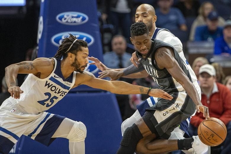 Brooklyn Nets forward Caris LeVert (right) suffered a gruesome right-leg injury with 3.7 seconds left in the first half of the game against the Minnesota Timberwolves on Monday. His right leg appeared to be bent inward at the ankle after he landed aw