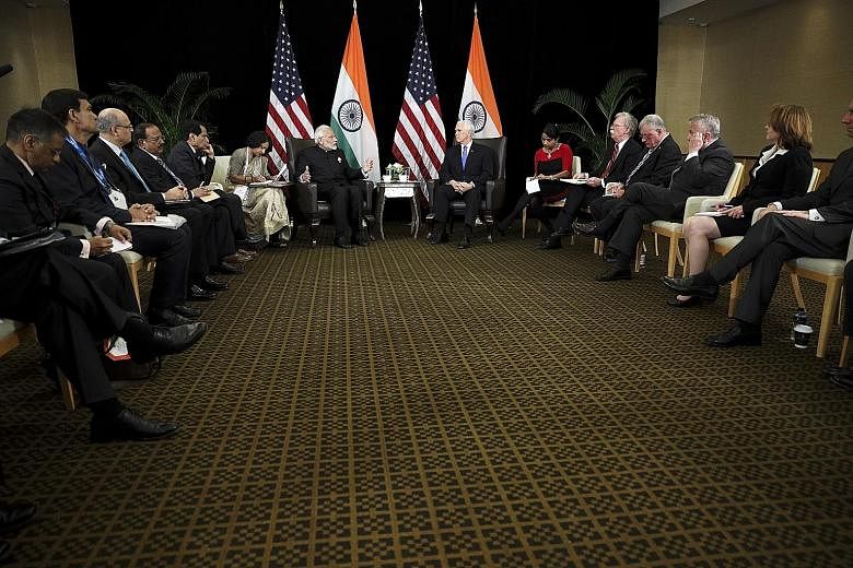 Indian Prime Minister Narendra Modi (centre, left) and US Vice-President Mike Pence attending a bilateral meeting yesterday held on the sidelines of the Asean Summit. During the meeting, Mr Pence and Mr Modi stressed the importance of the US-India st