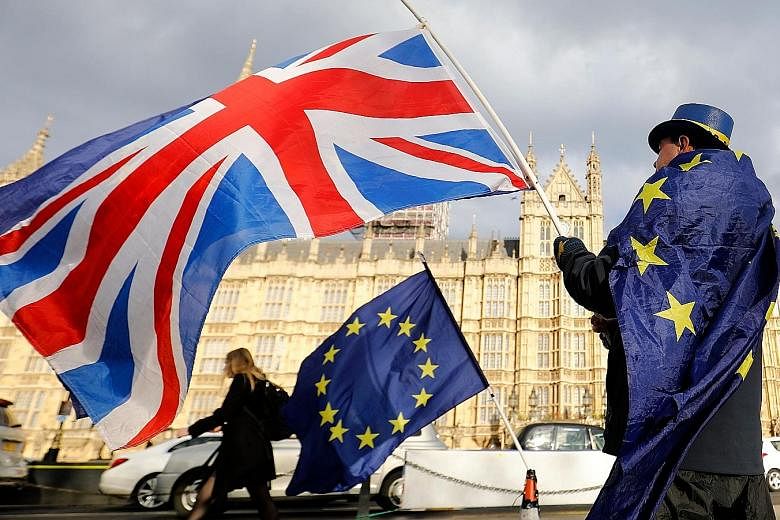 An anti-Brexit protester outside the Houses of Parliament in London on March 28. Under the terms of the so-called backstop guarantee - designed to avoid border checks on goods crossing the land frontier with Ireland - the whole United Kingdom will be
