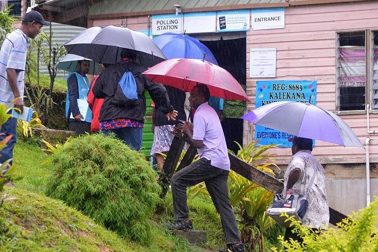 A queue to vote in the general election in Suva yesterday, although heavy rain dampened the turnout in the Fijian nation.