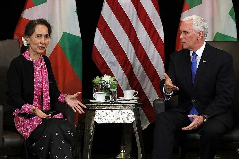 Myanmar's de facto leader Aung San Suu Kyi and United States Vice-President Michael Pence at a meeting yesterday. He condemned the "violence and persecution" against the Rohingya as "without excuse", and said he was "anxious to hear about the progres
