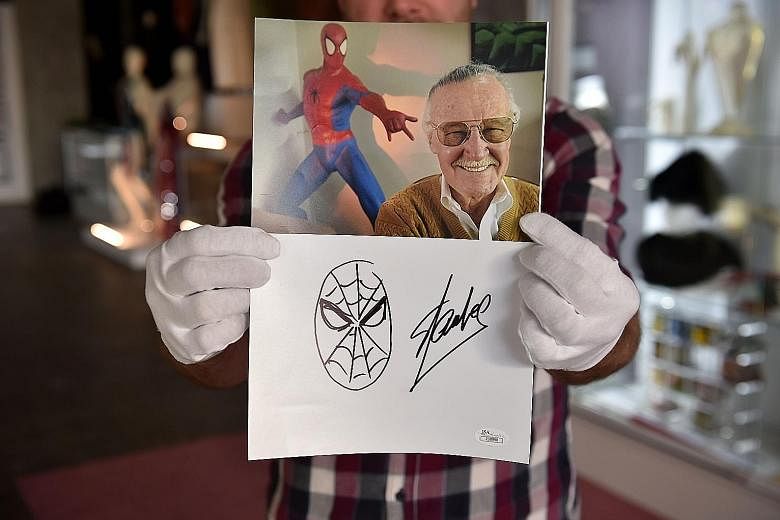 Many people, including this man dressed as Captain America, turned up at Stan Lee's Hollywood Walk of Fame star to pay tribute. An original sketch by Stan Lee of his most iconic creation, Spider-Man, beneath a portrait of Lee. The sketch is part of a