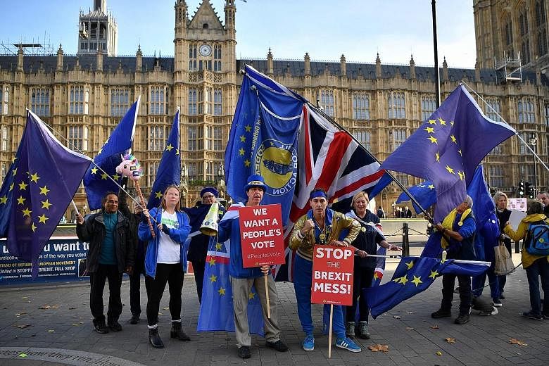 Anti-Brexit demonstrators waving the Union Jack and the European Union flag outside Parliament in London on Wednesday.