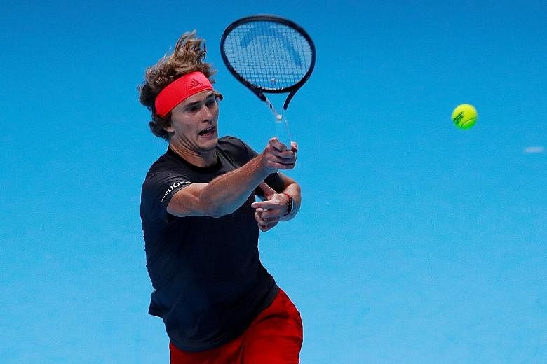 Alexander Zverev hitting a return in his ATP World Tour Finals match against Novak Djokovic at the O2 Arena in London on Wednesday. World No. 1 Djokovic qualified for the semi-finals after beating the fifth-ranked Zverev 6-4, 6-1 in what he called "n