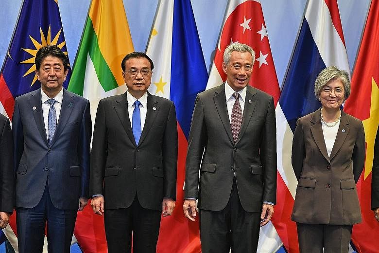 Prime Minister Lee Hsien Loong with (from far left) Japanese Prime Minister Shinzo Abe, Chinese Premier Li Keqiang and South Korean Foreign Minister Kang Kyung-wha at the Asean Plus Three Summit yesterday. The leaders agreed to speed up regional acti
