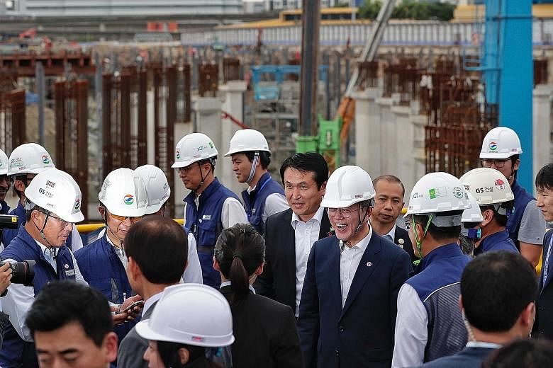South Korean President Moon Jae-in (centre, with helmet) visiting the East Coast integrated depot worksite yesterday.