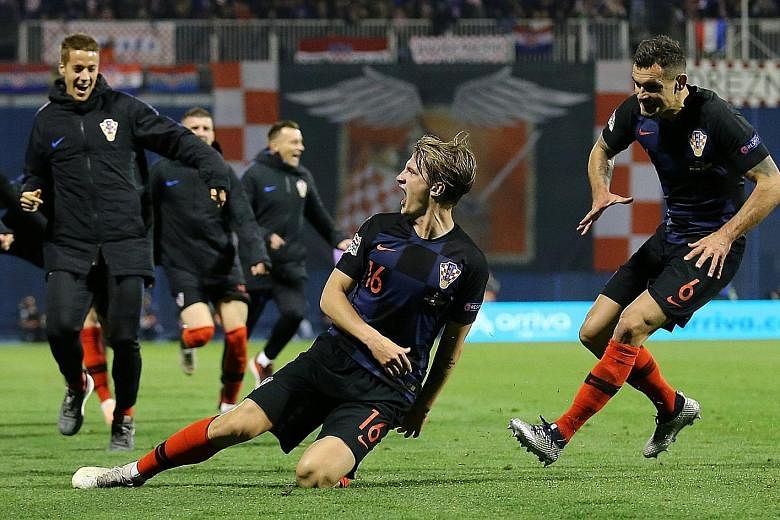 Tin Jedvaj is joined by teammates after scoring the winner in Croatia's 3-2 victory over Spain. Jedvaj's brace was his first international goals.