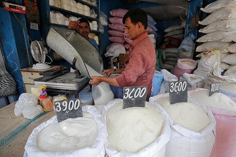 A worker packing sugar at a marketplace in Ahmedabad, India. Besides Australia, major sugar producers including Brazil and Thailand have also blamed India for contributing to a glut in the market that has forced prices down.