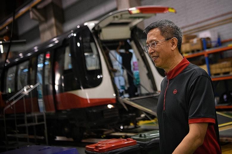 SMRT chief executive Neo Kian Hong visiting its Kim Chuan Depot yesterday. He said SMRT will be reorganised into five broad groups: trains, roads, experience, corporate services and a new engineering group.