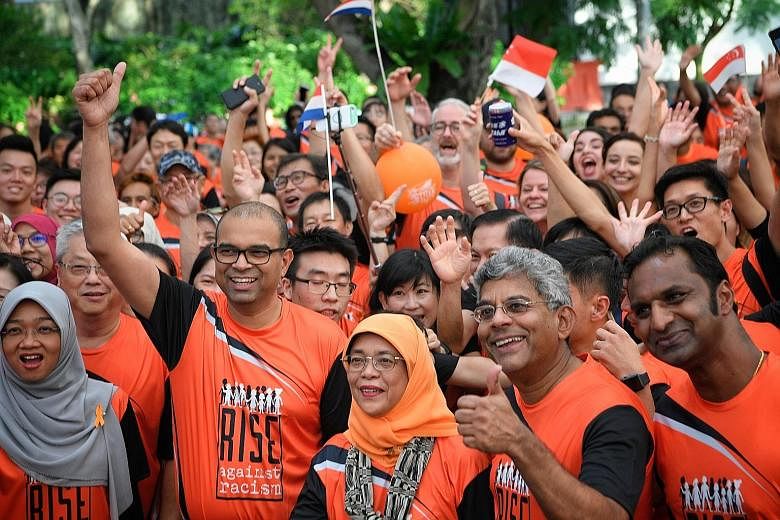 Close to 3,000 people showed up in support of the Rise Against Racism campaign yesterday at the Orange Ribbon Walk. They walked 3.8km around the Marina Bay area, accompanied by President Halimah Yacob (front, centre), who flagged off the walk at Espl