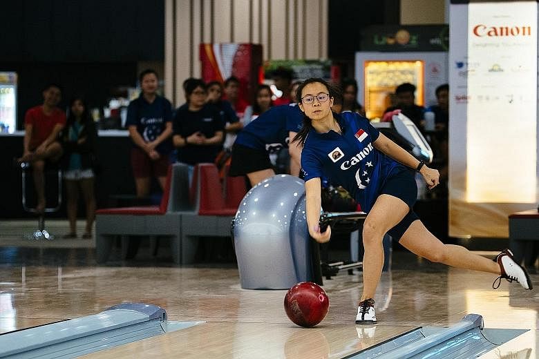 Charlene Lim, 19, cruised to a 203-155 pinfall victory over Geraldine Ng to clinch the women's title in the 49th Singapore National Championships yesterday at the SingaporeBowling @ Rifle Range bowling centre. Fellow teenager Jomond Chia, 18, was the